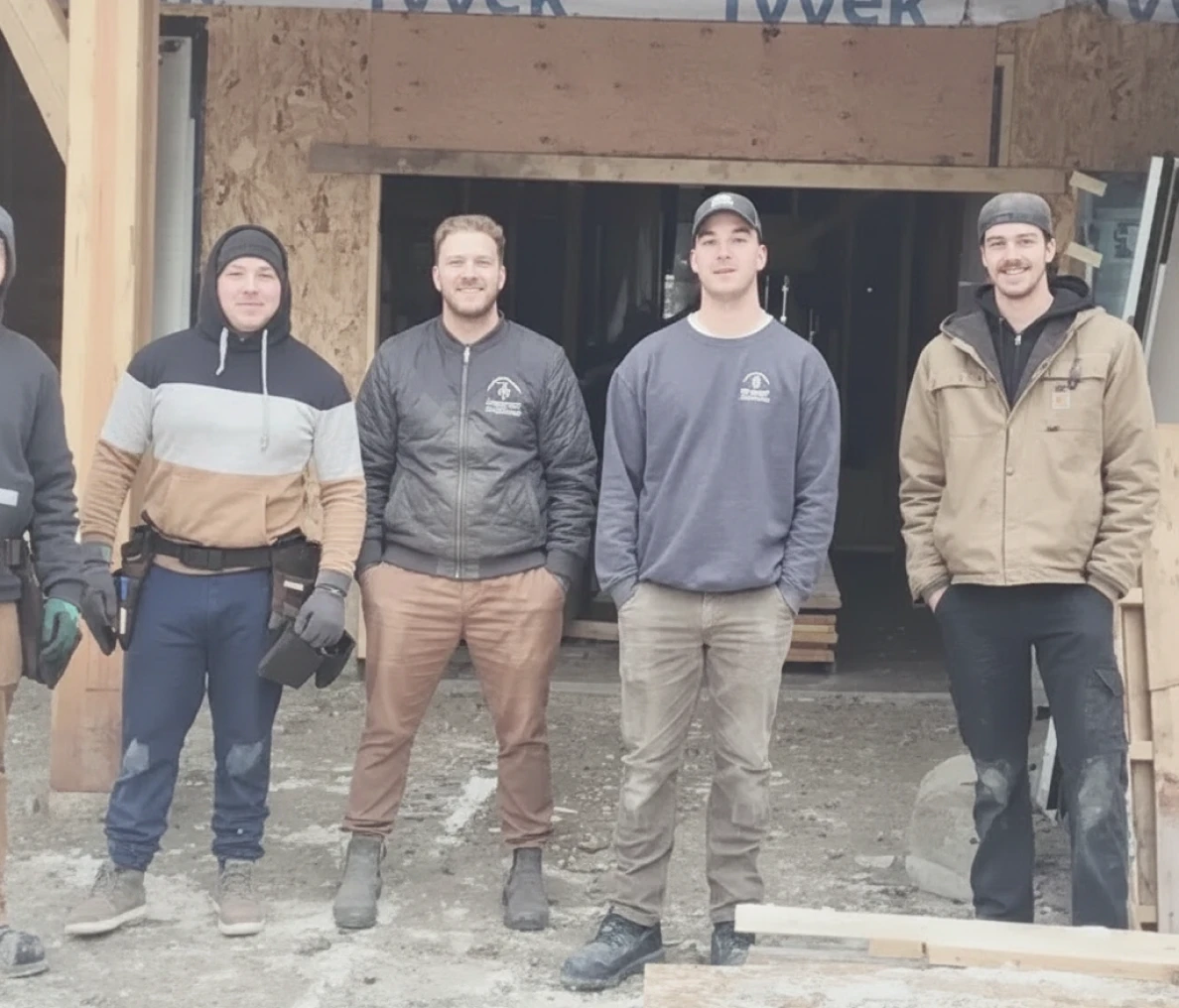 Group of workers posing at construction site.
